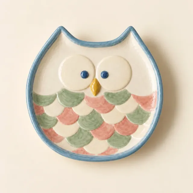 Owl dish with a blue rim, green and pink feathers, ivory eyes and a yellow beak.